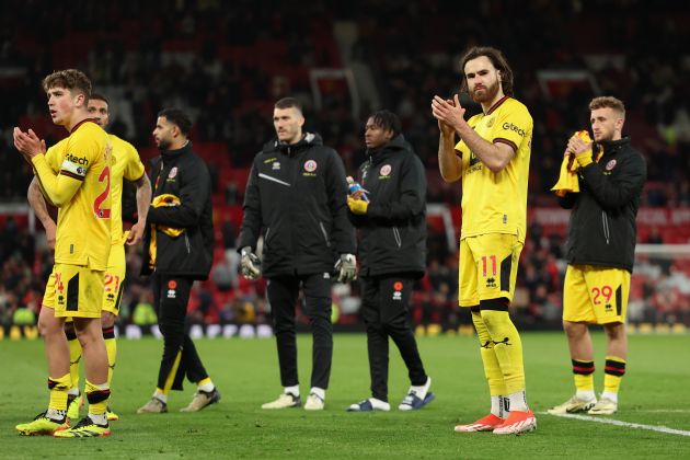 Sheffield United players clap fans at Old Trafford.